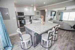 a kitchen with a island with chairs and a counter top at Beachfront Retreat! 3 Steps to WALKOVER! in Surfside Beach