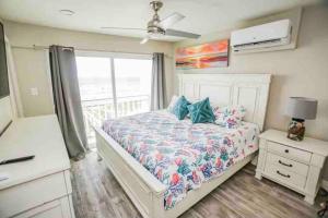 a bedroom with a bed with a dresser and a window at Beachfront Retreat! 3 Steps to WALKOVER! in Surfside Beach