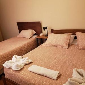 two beds sitting next to each other with towels on them at CASA VICTORIA in San Pedro de Atacama