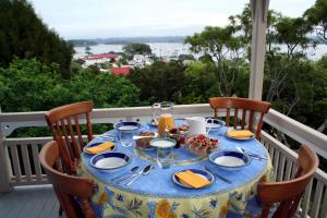 a table with a blue table cloth on a balcony at Villa Russell in Russell
