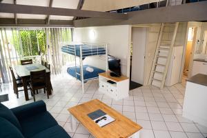 a living room with a couch and a bunk bed at Kellys Beach Resort in Bargara