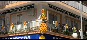 un edificio con un balcón con flores. en Hostal Boutique Luna de Gavín en Cullera