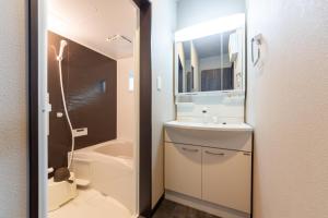 a bathroom with a sink and a toilet and a shower at FAMILIA糀谷 in Tokyo +26 photos