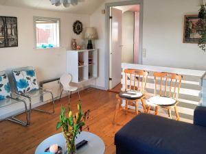 a living room with two chairs and a couch at 6 person holiday home in Hadsund-By Traum in Hadsund
