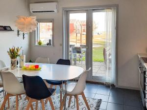 a kitchen and dining room with a white table and chairs at 6 person holiday home in Hadsund-By Traum in Hadsund