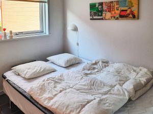 an unmade bed with two pillows in a bedroom at 6 person holiday home in Hadsund-By Traum in Hadsund