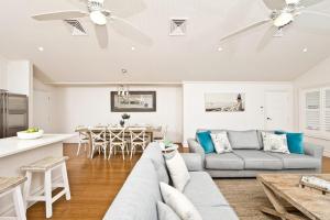 - un salon avec un canapé et une table dans l'établissement The Hamptons Beach House near Dutchie's walk to Nelson Bay, à Nelson Bay