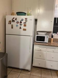 a white refrigerator in a kitchen with a microwave at Manuel Y Sonia-La casa de los Angeles in Long Beach