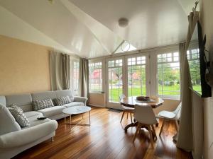 a living room with a couch and a table at Villa Nord in Norddeich