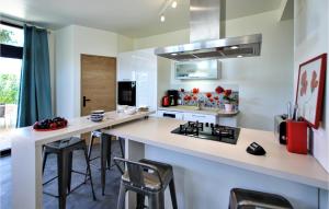 a kitchen with a counter and a kitchen island with stools at Amazing Apartment In St Romans With Kitchenette 