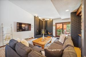 a living room with a couch and a table at Twins Getaway at Meadow Creek Duplex in Frisco