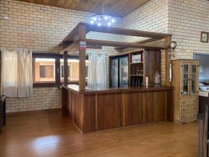 a bar in a room with a brick wall at Pousada Rural Encanto do Riacho in Bom Jardim da Serra +47 photos