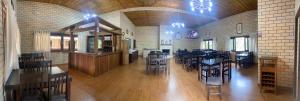 a large room with tables and chairs in a restaurant at Pousada Rural Encanto do Riacho in Bom Jardim da Serra