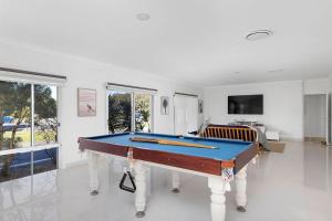a living room with a pool table in it at The Home Resort - One Mile Beach in One Mile
