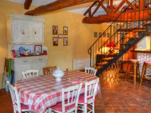 a dining room with a table and a staircase at Gîte de charme avec piscine couverte entre Châteaux de la Loire et Futuroscope - FR-1-381-520 in Draché