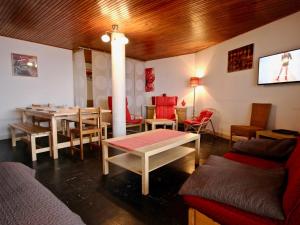a dining room with a table and chairs at Appartement Chamrousse, 3 pièces, 8 personnes - FR-1-549-108 in Chamrousse