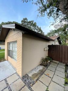 a house with a garage with a fence at Adorable Suite in Tampa. in Tampa