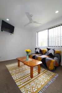 a living room with a couch and a coffee table at BLK Stays Guest House Deluxe Units Bellmere 