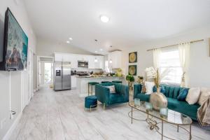 a living room with a blue couch and a kitchen at Modern Luxury Home Located in Tampa! in Tampa