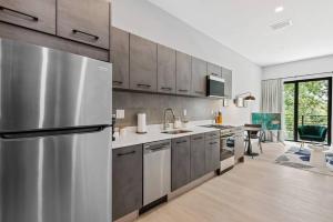 a large kitchen with a stainless steel refrigerator at Pretty Rola 304 Luxury Apt w King Bed Central Area in Fort Lauderdale