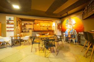 a restaurant with tables and chairs and a painting of a cowboy at Sosa House Eco Hotel Boutique in Huaraz