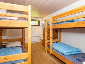 a bedroom with two bunk beds in a cabin at 11 person holiday home in Ørsted-By Traum in Ørsted