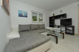 a living room with a couch and a glass table at Apartments by the sea Tkon, Pasman - 19017 in Tkon