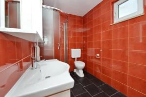 a bathroom with a white sink and a toilet at Apartments by the sea Tkon, Pasman - 19017 in Tkon +20 photos