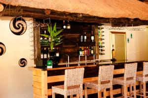 a bar with chairs and a counter in a restaurant at Avela Lodge in Hekpoort