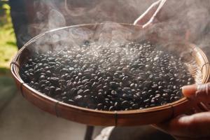 a person holding a bowl filled with black seeds at Bang Po Hut in Ban Bang Po