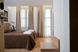 a bedroom with a bed and a window at Chic Hotel in Athens