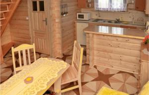 a small kitchen with a table and a table and chairs at 2 Bedroom Stunning Home In Sianozety in Sianozety