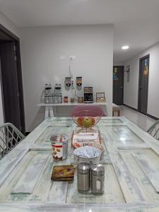 a kitchen with a table with a bowl on it at Casa Tangara Café y Hospedaje in Medellín +15 photos