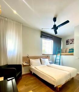 a bedroom with a bed and a ceiling fan at 1000Nights B St in Tel Aviv