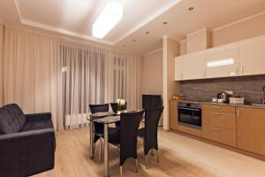 a kitchen and dining room with a table and chairs at Sonia Apartments in Jūrmala