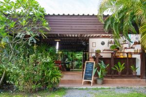 a coffee shop with a sign in front of it at Bang Po Hut in Ban Bang Po