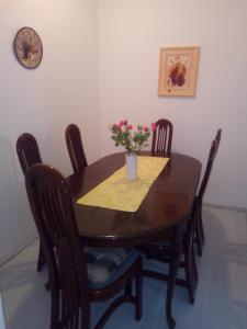 a dining room table with a vase of flowers on it at Apartments by the sea Brist, Makarska - 19330 in Podaca