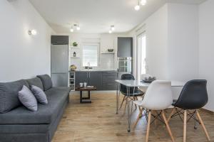 a living room with a couch and a table and chairs at Apartments with parking space Vir - 19332 in Vir