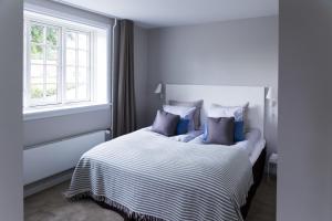 A bed or beds in a room at Rungstedgaard