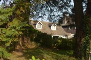 a large house with trees in front of it at Walkers Retreat with garden and views in Holne