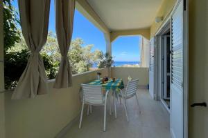a table and chairs on a balcony with a view of the ocean at Apartments by the sea Lun, Pag - 19358 in Lun