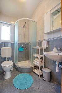 a bathroom with a shower and a toilet and a sink at Apartments by the sea Rogoznica - 19367 in Rogoznica