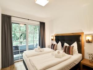 two beds in a hotel room with a window at Luxurious holiday home with sauna in Krimml