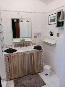 a bathroom with a sink and a mirror at Residenza Schinardi in Oristano