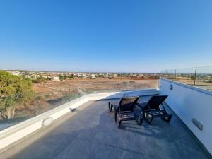 a balcony with two chairs and a view of the desert at Lucky Strike Apartment in Nicosia