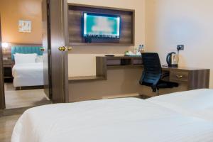 Säng eller sängar i ett rum på Hotel Horizon Entebbe