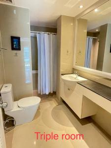 a bathroom with a toilet and a sink and a mirror at Thalassa pool Kata Beach in Kata Beach