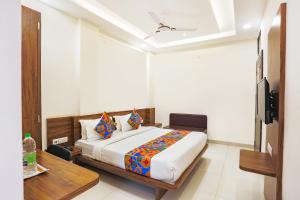 a bedroom with a bed and a television in it at FabHotel Balaji Paradise in Indore