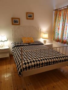 a bed with a black and white comforter in a bedroom at Ground Floor Slievemore Apartment in Bellanasally