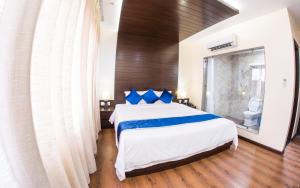 a bedroom with a large bed with blue pillows at Kaveri Inn in Kathmandu